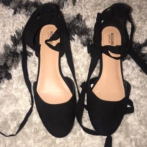 Black flats with ankle ties